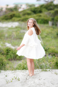 Senior portraits of beautiful young lady in white dress