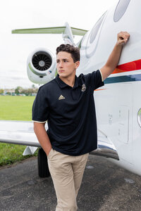 Boy by jet plane Senior photo