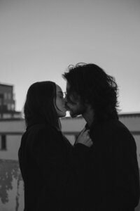 Couple kissing on rooftop in albuquerque new mexico.