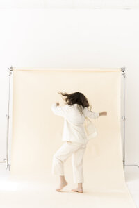 woman dances in front of backdrop