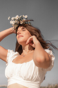 Photo of woman with closed eyes and flowers