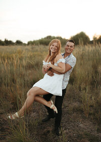 Man carrying her fiance happily