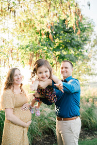 black and whte photo with a Mom of three  children playing at Natirar Park in Somerset NJ