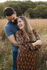 husband and wife hugging for family photos