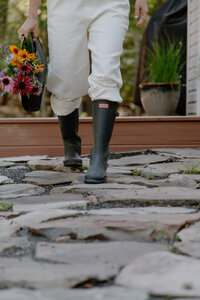 Sam walking in her garden with rubber boots