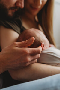 close up photo of a newborn babies hand grasping his dads hand