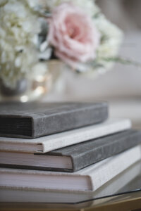Wedding album with distressed black leather spine and sand linen cover for a modern rustic look.