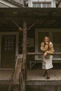 Candid portrait of Rae Terrillon holding a camera, capturing storytelling moments on Vancouver Island