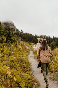 couple walking up a mountain in the fall