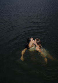 A couple kissing in the water after jumping in