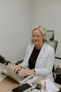 Doctor typing on a computer