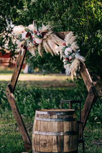 hexagon wedding arch with flowers and whiskey barrel