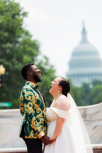 Newlyweds laughing and holding hands