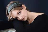 Close-up fine art portrait of a young woman in a black top with blue eyes and a patterned headband, photographed by The Picture House in Birmingham, Alabama.