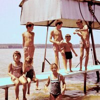 Young children playing at the lake dock