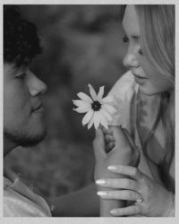 cozy couple laying on a blanket with intertwined hands captured during a Kansas lifestyle session

