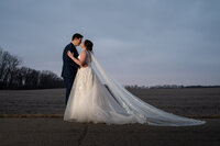 Groom embraces and lifts his bride for a kiss on their wedding day