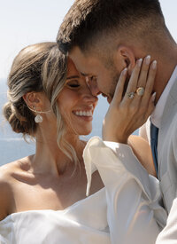 bride holding grooms cheek