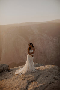 Bride stands in Yosemite in her wedding attire