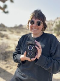 Elopement photographer in Joshua Tree holding a film camera