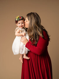 Beautiful mother inside a bathtub with a little baby