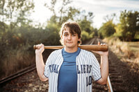 Senior Photography, boy posing with baseball bat and jersey