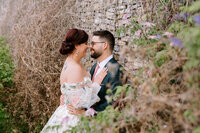 A bride and groom smile at each other at Ralph Klein Park in Calgary, Alberta