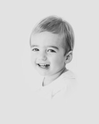Toddler boy smiles for heirloom portrait at Raleigh NC studio