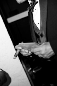 Groom holding vows with a cigar, a memorable moment captured by Priscila Del Cristo, wedding photographers in Tampa.