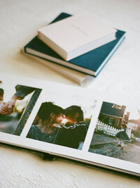 heirloom photo album stack with family album open to show pages by huntsville family photographer