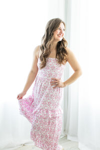 Holly smiling in a blue and white dress