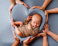 newborn photography in a heart bowl with family