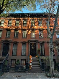Brownstone house in Brooklyn decorated with pumpkins for autumn.