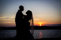 Sunset silhouette of couple hugging