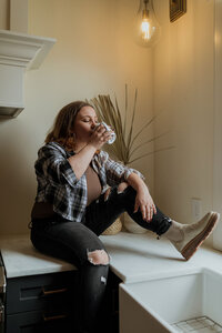 woman sitting on counter