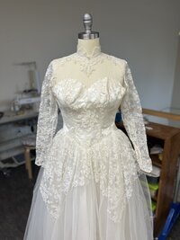 heirloom bridal gown displayed on mannequin