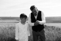 grooms helps son with cufflinks