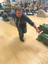 Man bowling at bowling alley holding ball on lane throwing bowling ball, adoption agencies near me, baby adoption, infant adoption, giving up my baby, new york, long island