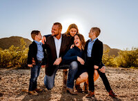 Phoenix family posed by photographer  for a picture in the Arizona desert