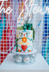 vibrant and colourful wedding cake with cactus and floral designs