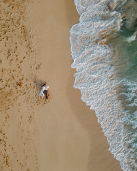 couple laying on sand