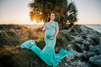Pregnant woman in blue flowing dress at a Maternity session in Clearwater, FL