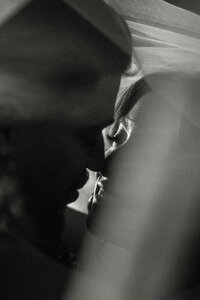 Bride and Groom in Black and White, bride's veil is flying in the wind at an intimate chapel in Lancaster, PA