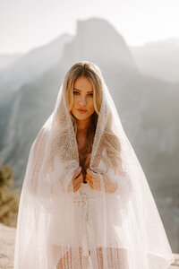 bride with veil wrapped around her