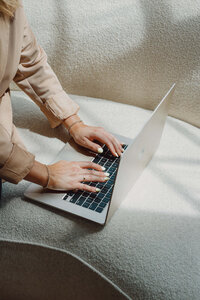 A close-up aesthetic image of hands typing on a laptop, representing online work and website design. Suitable for websites offering digital marketing services or showcasing the process of creating a visually appealing website.
