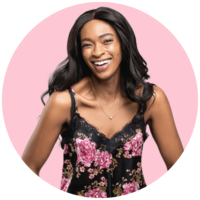 Lisa Simone Richards, wearing a pink and black floral top, smiles.