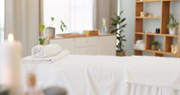 Massage table prepared with fresh towels and candles in a cozy treatment room at LivingTree Clinical Massage and Skin, Greenville, SC