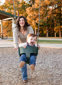 MOMMY PUSHING TODDLER IN A SWING AND HE IS LAUGHING
