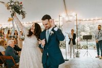 bride and groom celebrating as they walk back up the aisle