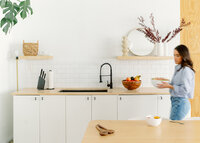 Branding session of woman carrying bowl in a bright setting